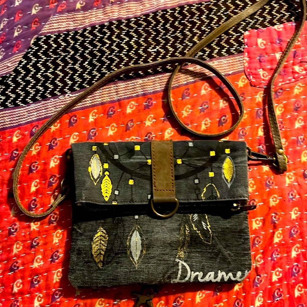 Mona B Dreamer crossbody. Leather strip and closure.